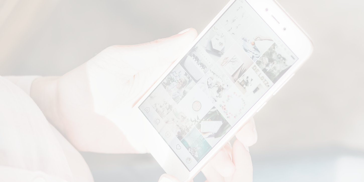 Person holding smartphone displaying social media feed.