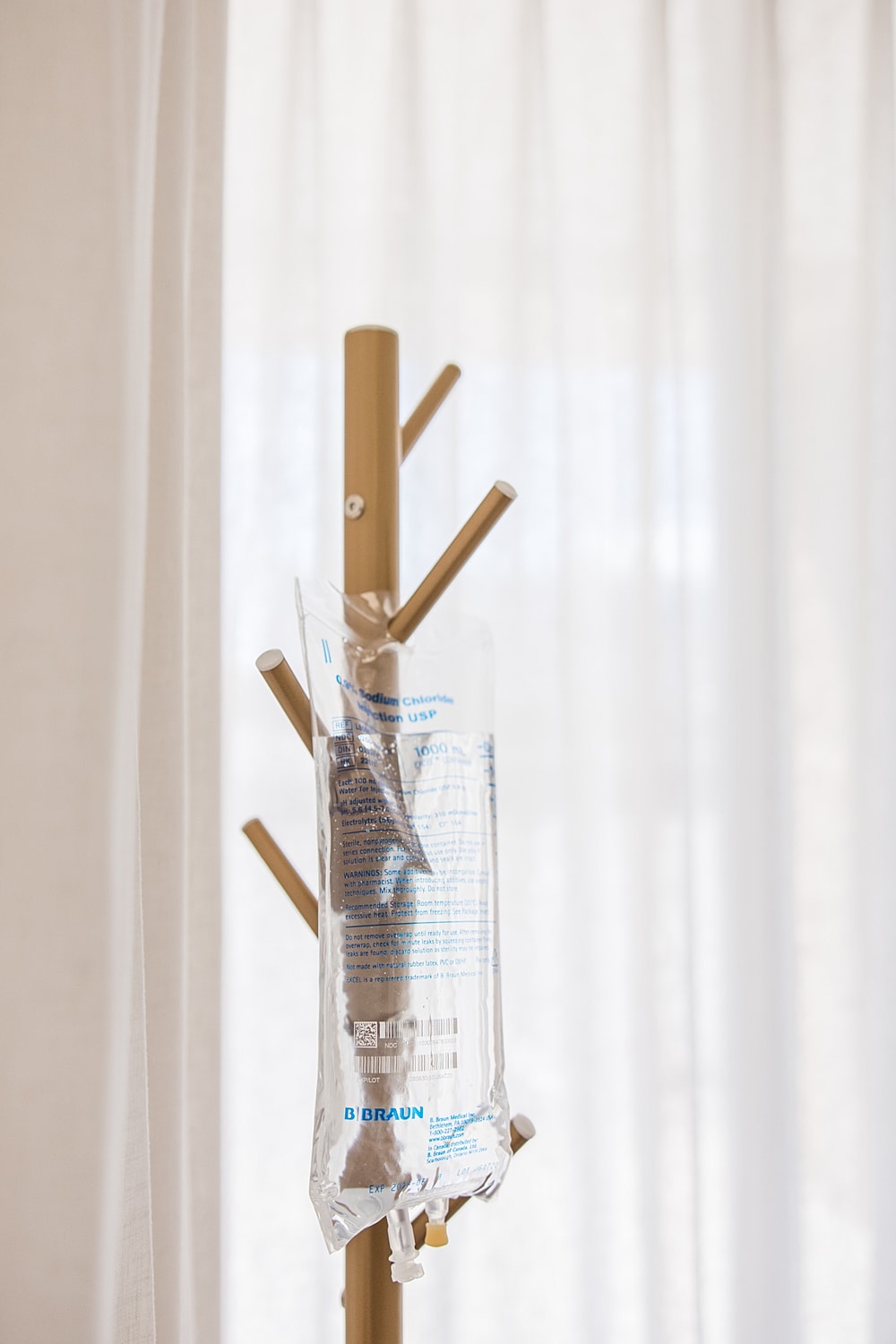 IV bag hanging on modern gold stand.