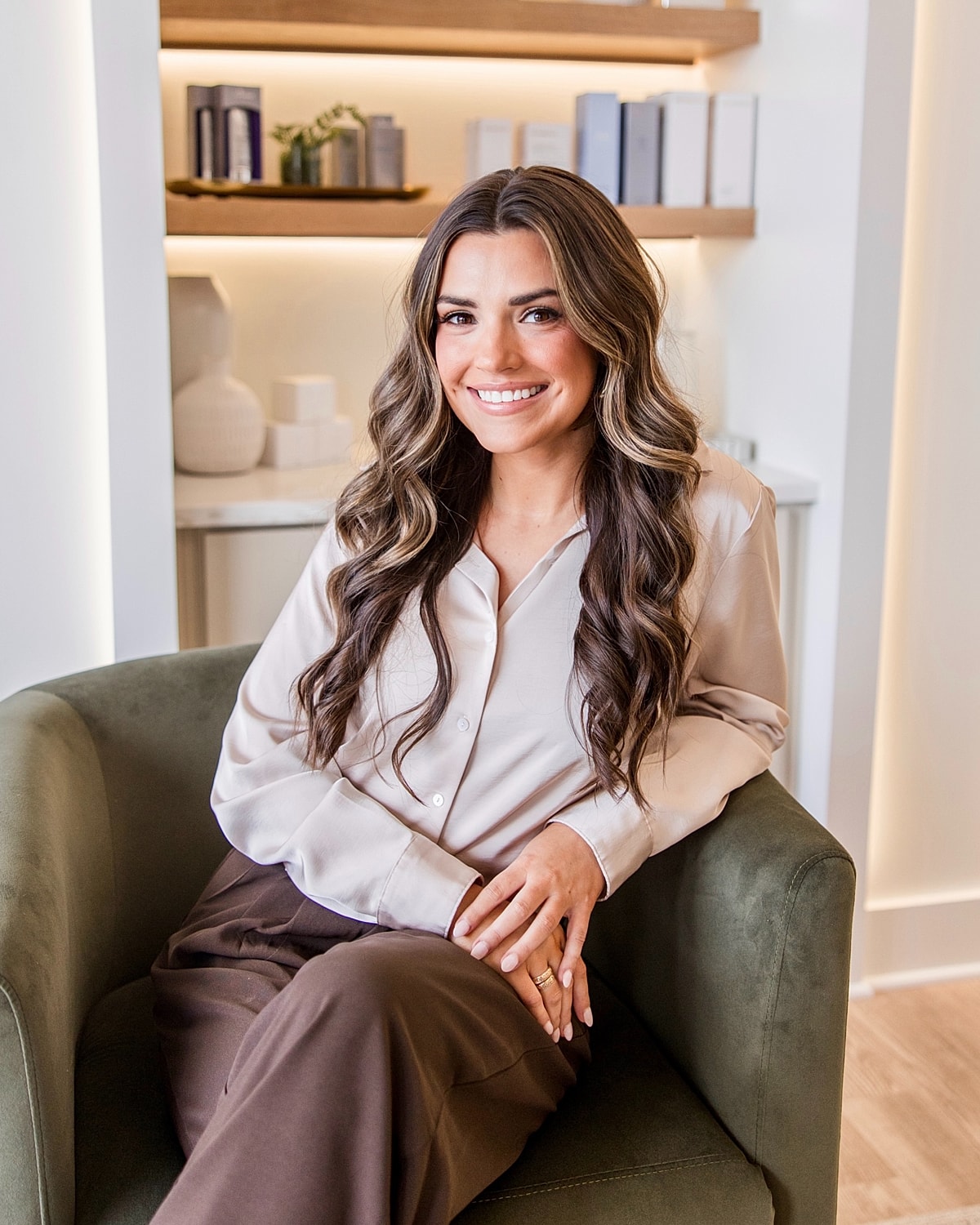 Smiling woman seated in stylish modern chair.