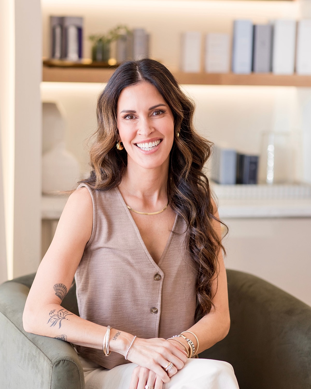 Smiling woman sitting on a green chair.