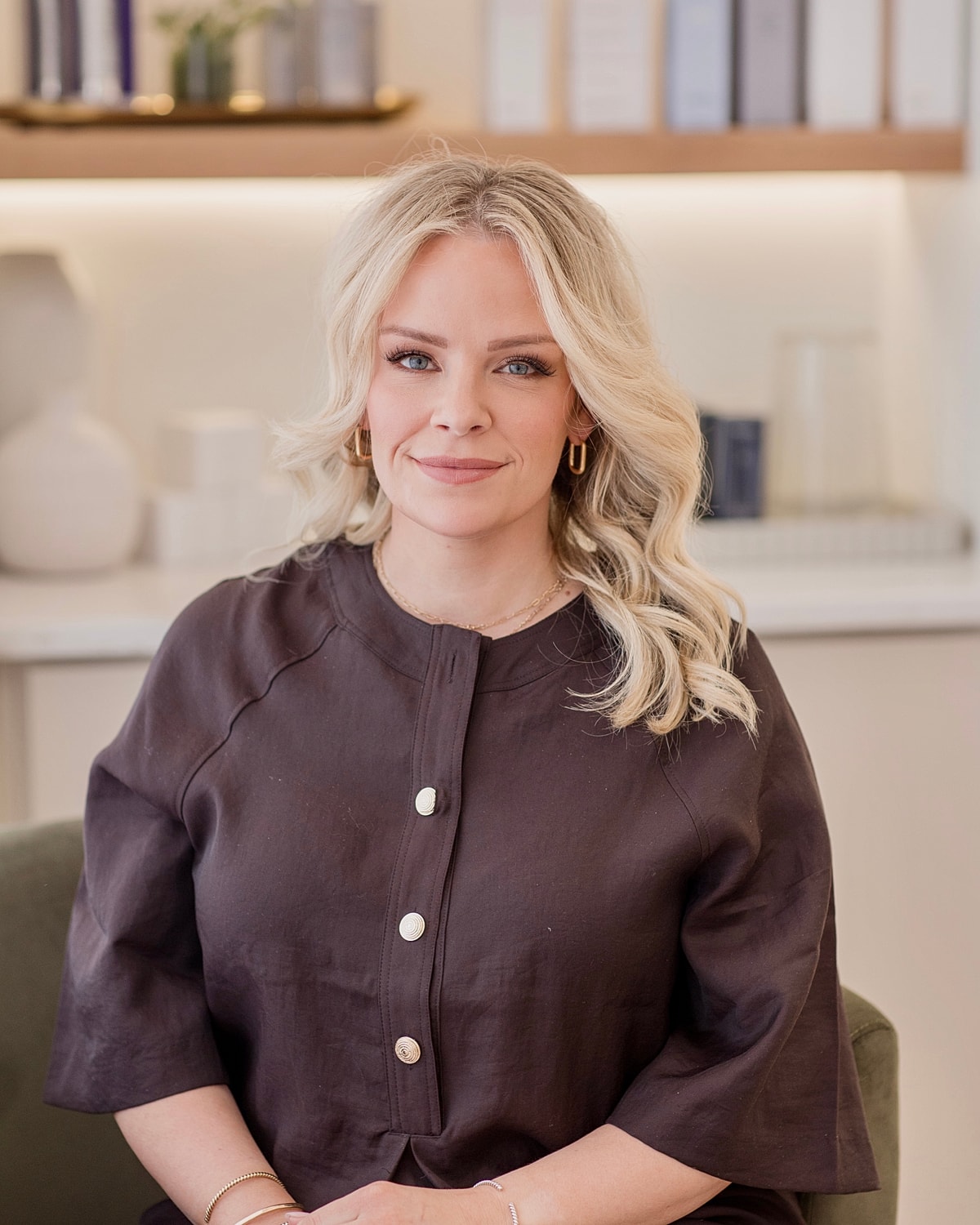 Person smiling in a modern interior setting.