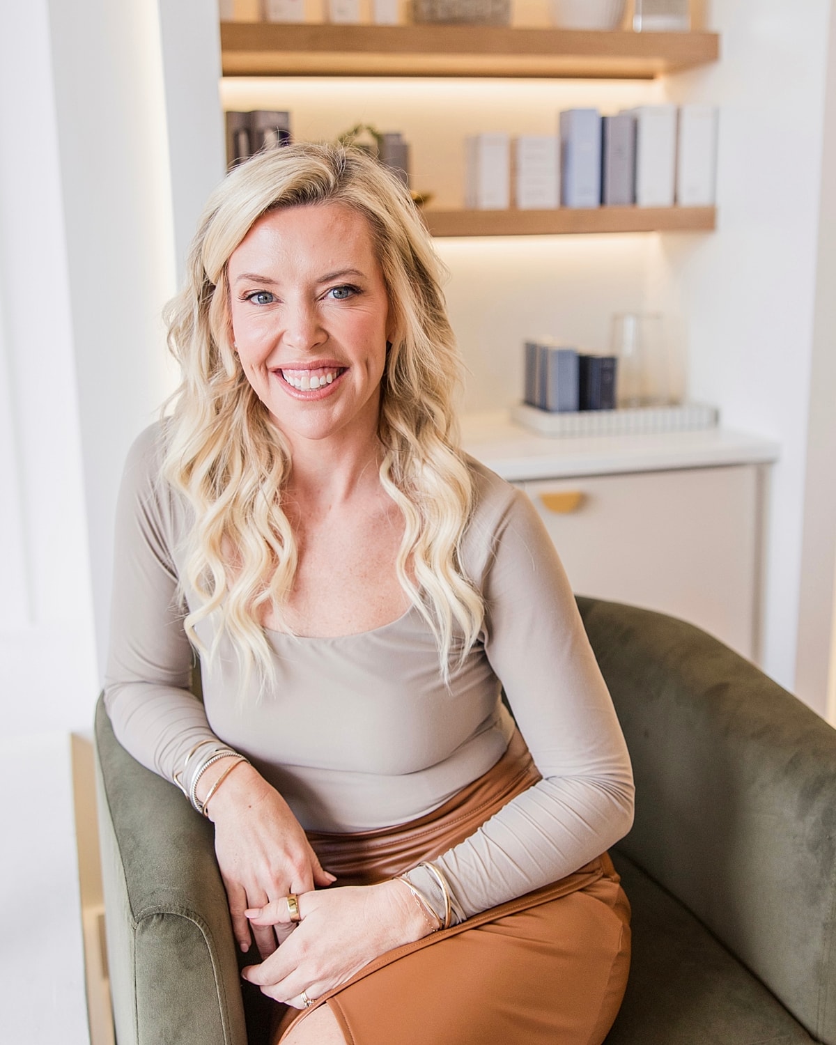 Smiling woman in a stylish modern setting.