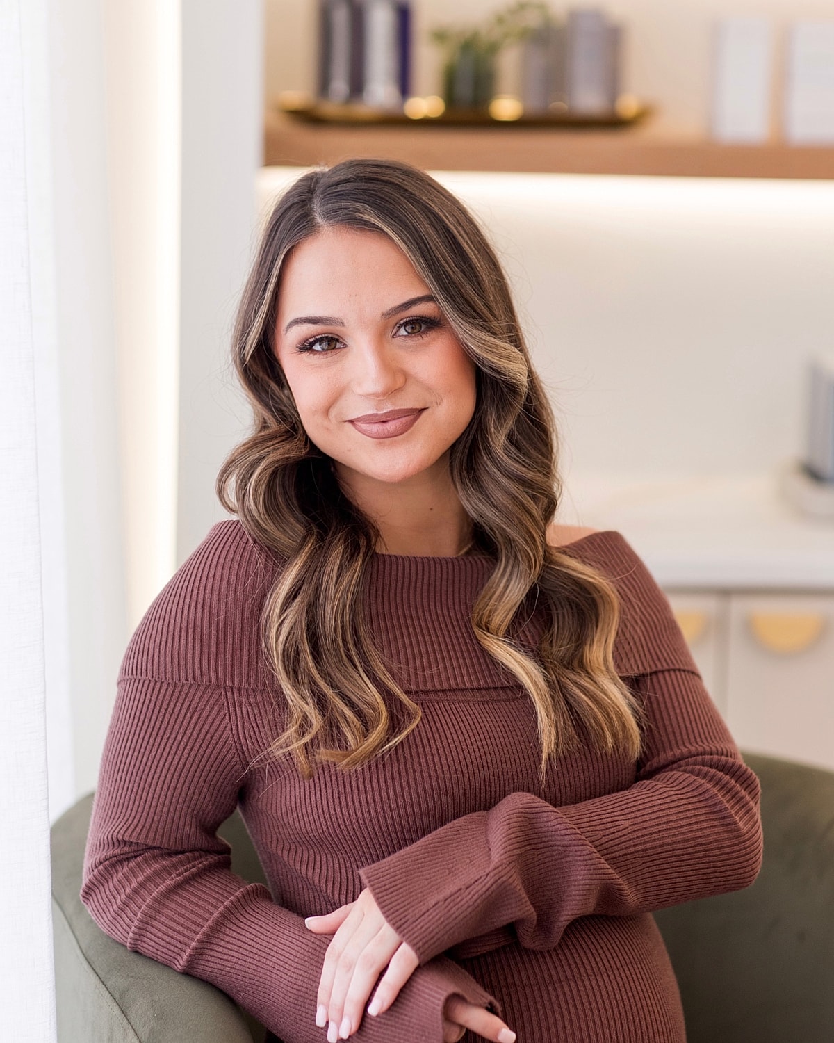 Woman smiling in a cozy, modern interior.