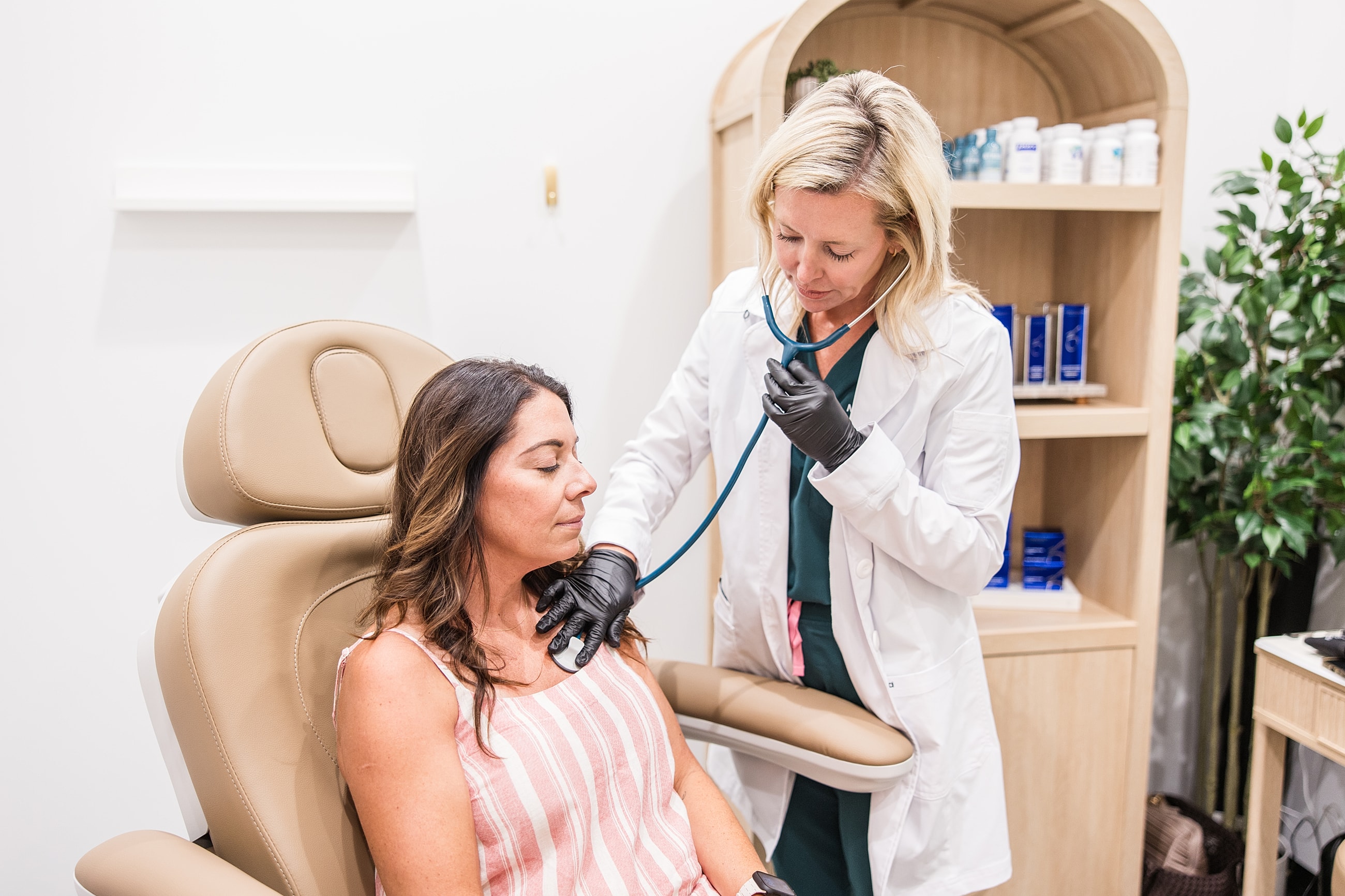 Medical professional examining patient in clinic.