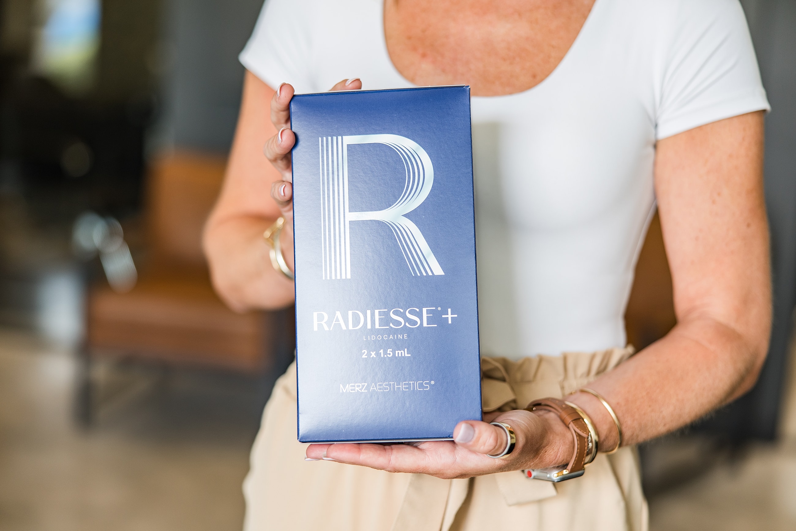 Box of Radiesse+ injectable treatment being held.
