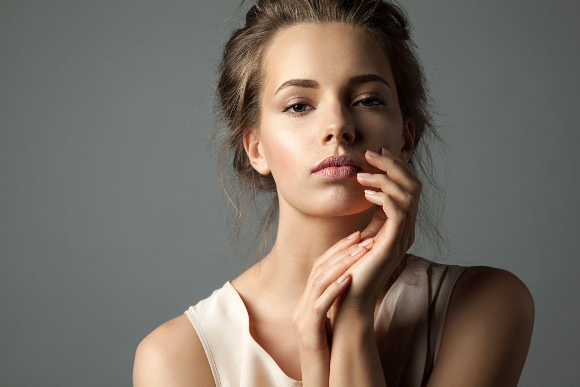 Portrait of a woman with elegant hand pose.