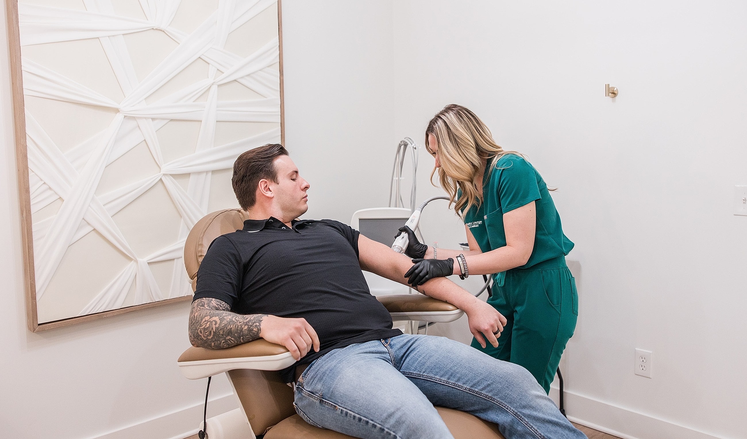 Woman administering treatment to man in clinic.