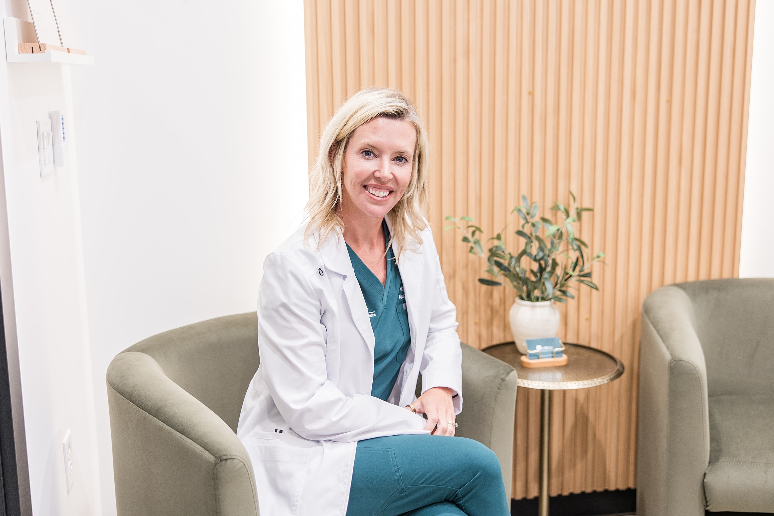 Smiling healthcare professional in modern office setting.