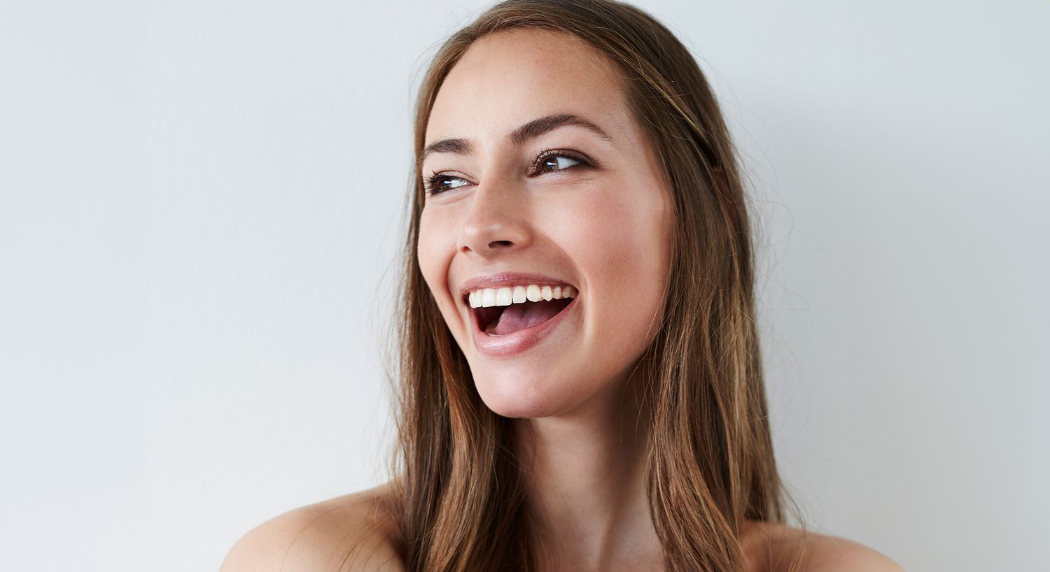 Portrait of a woman with hands on face.